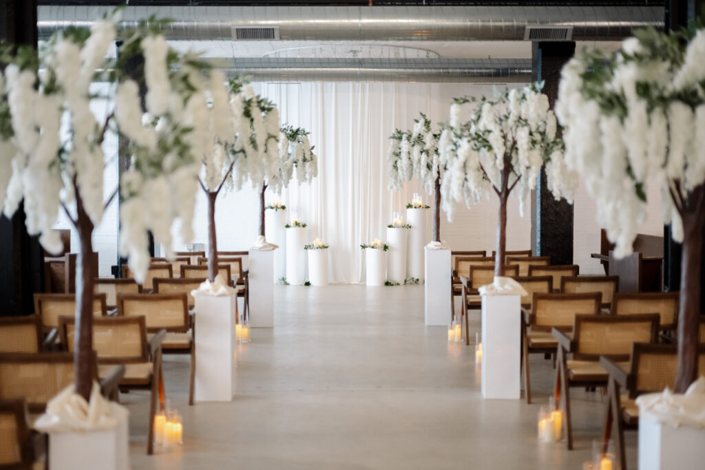 Romantic indoor wedding ceremony setup at The Collins at the Clock Tower Detroit featuring historic architecture and elegant seating.