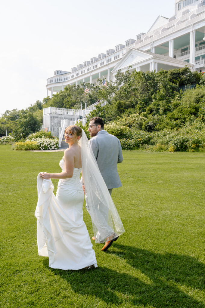 Wedding at the Grand Hotel Mackinac island. Couple walking in the grass
