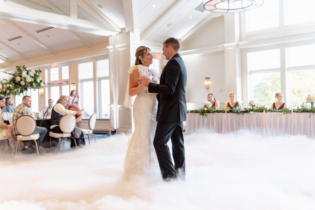 Bride and groom first dance in the clouds. Using dry ice to make a fog along the ground.