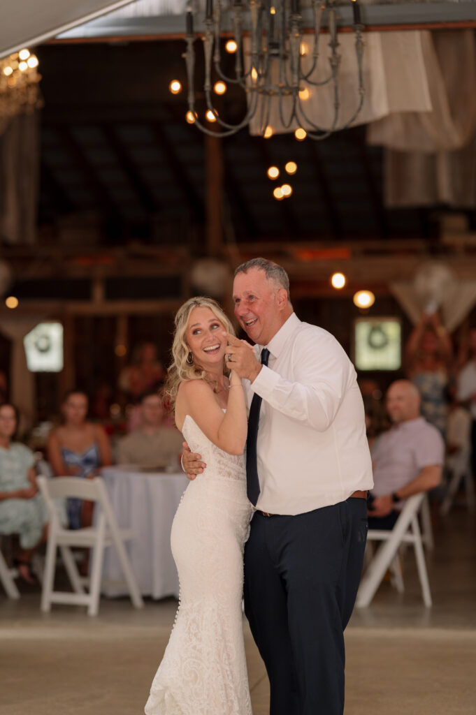 Bride and Father share a dance on the dance floor at the wedding reception