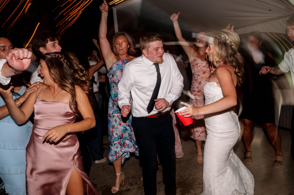Bride and groom getting down and dancing on the dance floor.