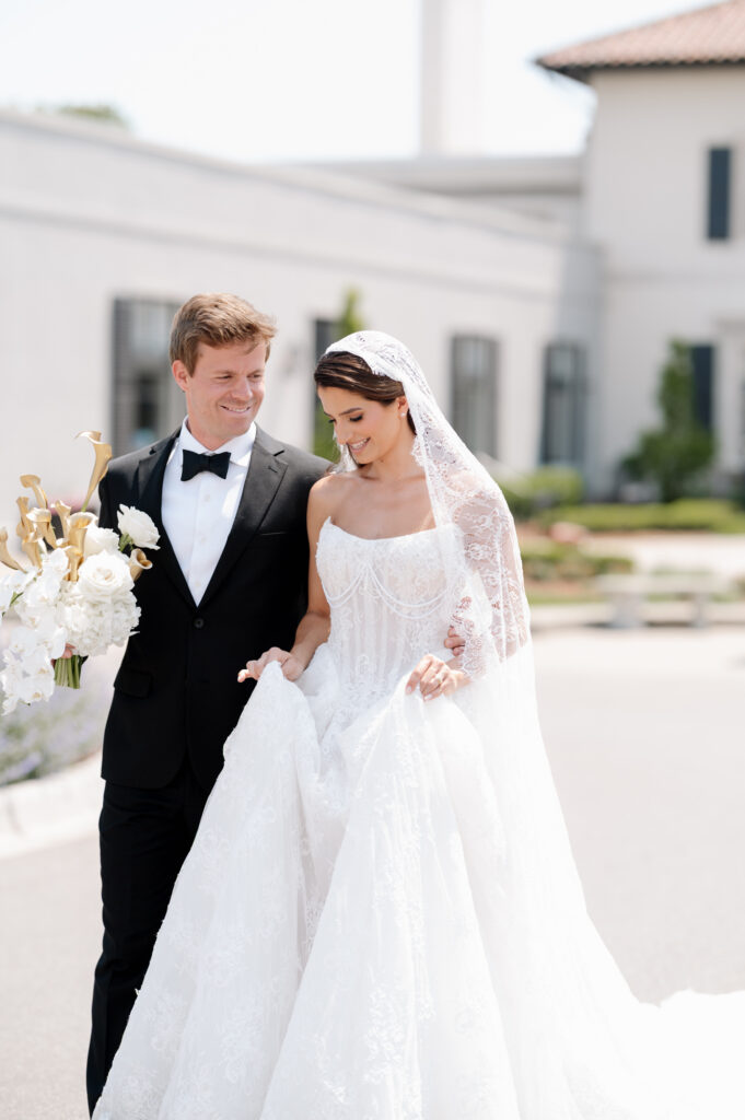 Luxury wedding bride and groom sitting in a vintage Porsche in front of a historic mansion during an elegant editorial style wedding photoshoot.