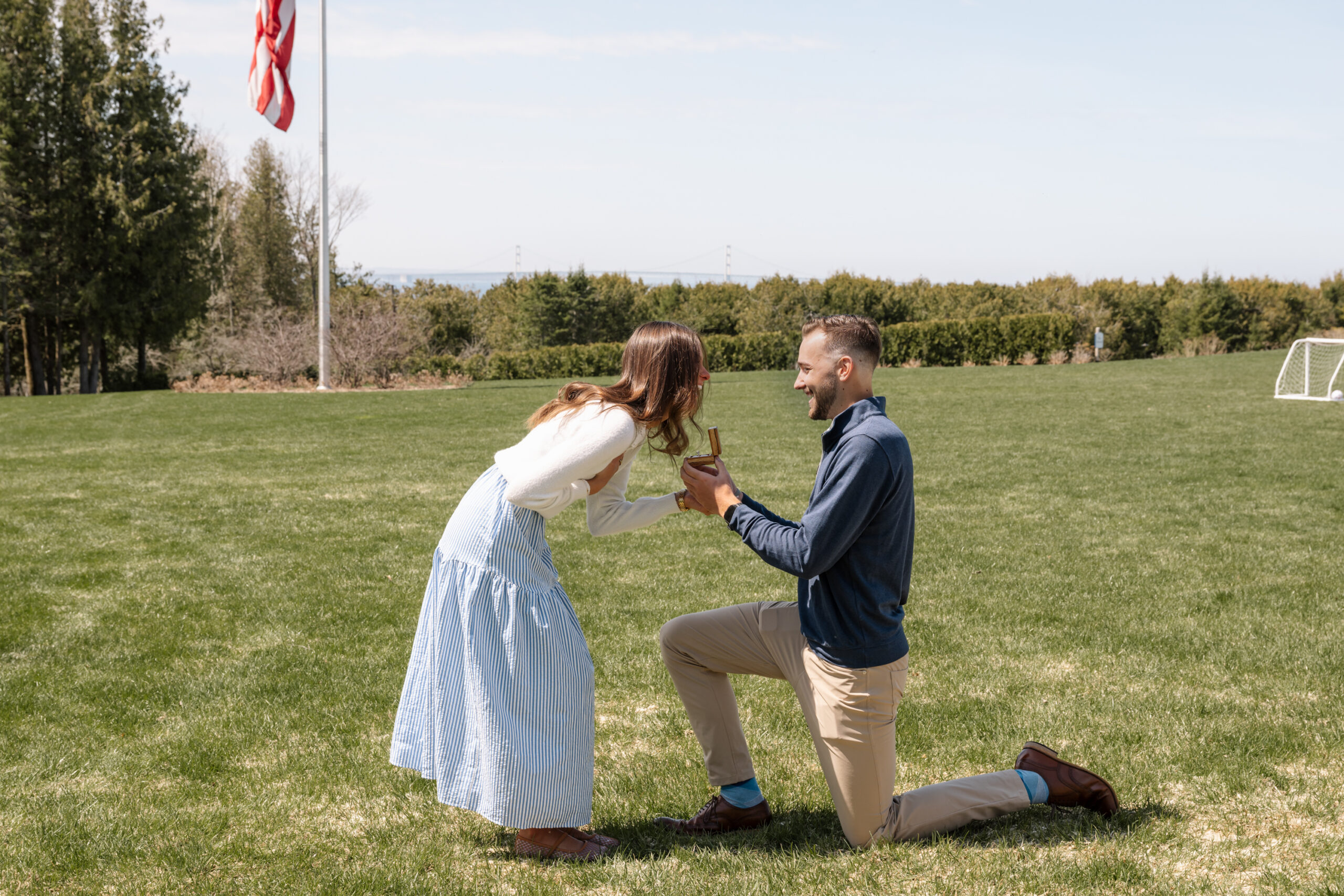 Couple celebrating their surprise engagement proposal at The Inn at Stonecliffe overlooking Lake Huron on Mackinac Island.